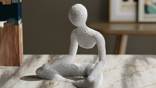 Decorative sculpture of a seated figure on a marble surface